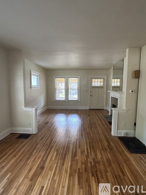 A room with wooden floors and white walls.
