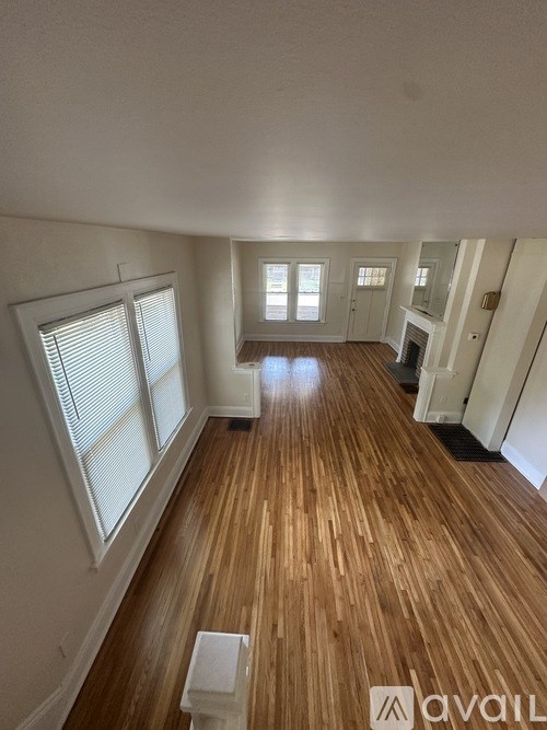 A room with wooden floors and white walls.