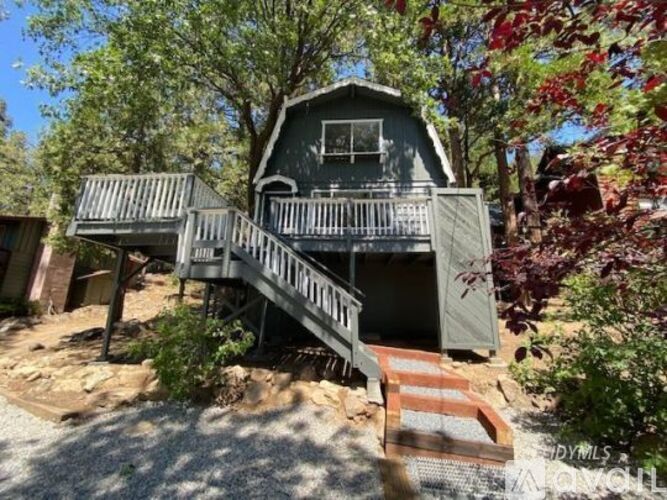 A house with a balcony and stairs leading to it.
