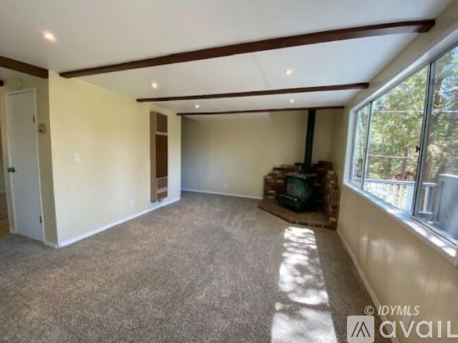 A living room with a fireplace and a television.