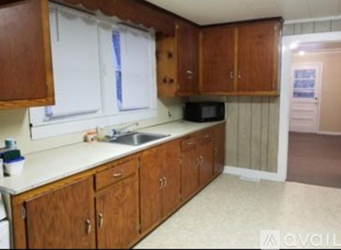 A kitchen with wooden cabinets and a white countertop.