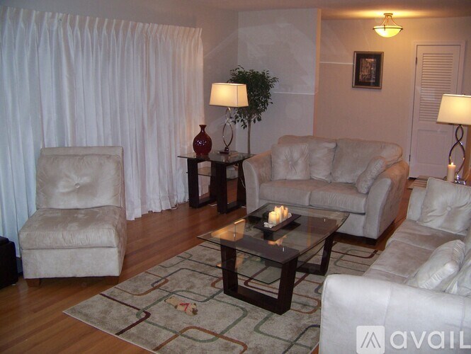 A living room with a couch, chair, and table.