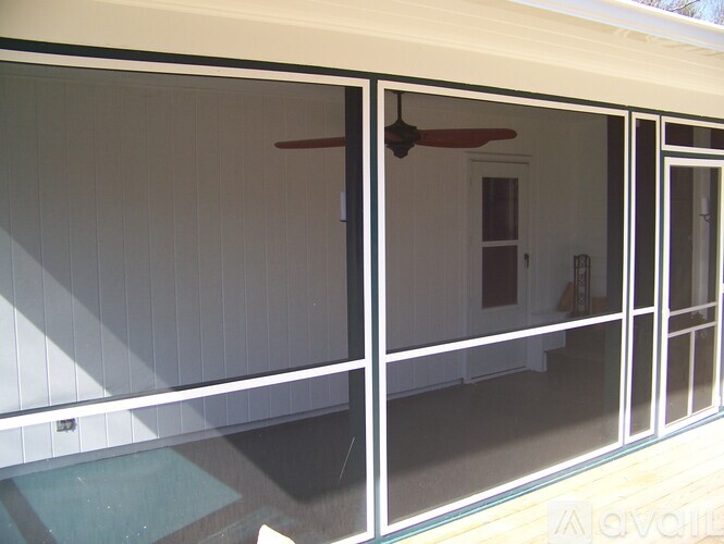 A patio with a pool and a fan.