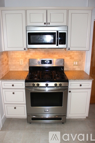 A kitchen with a stove top oven and microwave above it.