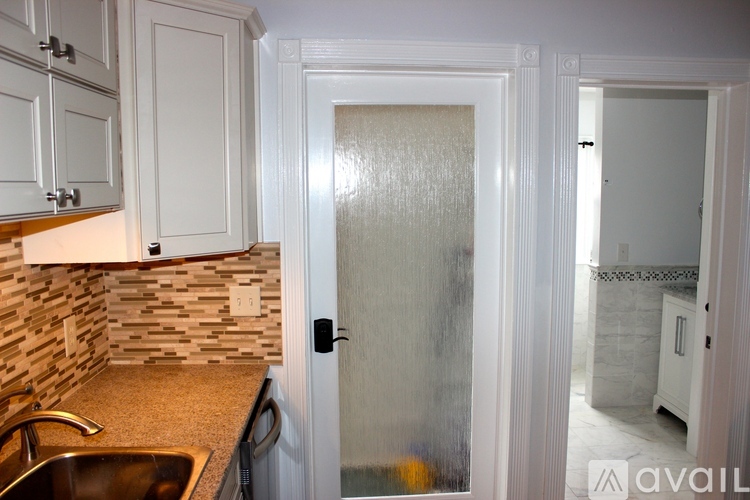 A kitchen with a sink and cabinets.