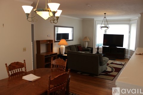 A living room with a brown table and chairs.