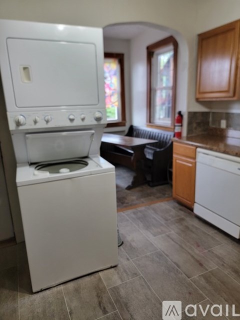 A white oven with a stove top sits in a kitchen.