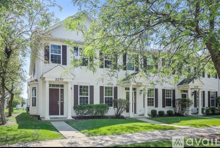 A white house with black shutters and a porch.
