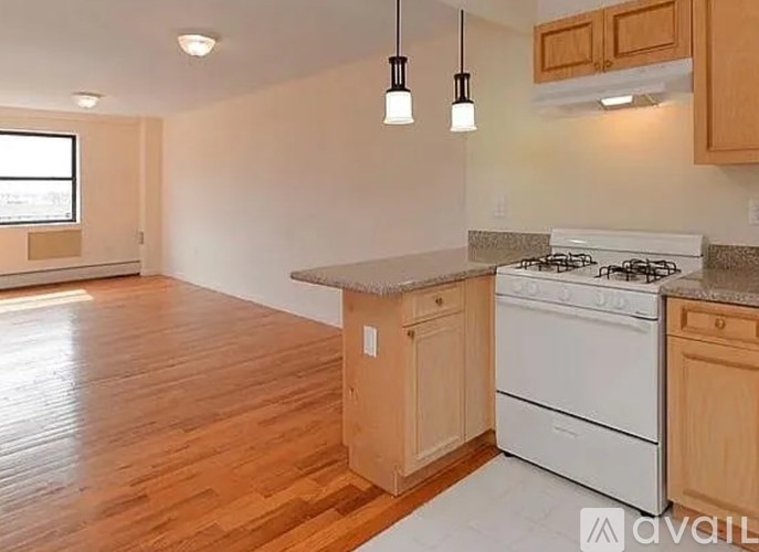 A kitchen with wooden cabinets and a white stove top oven.