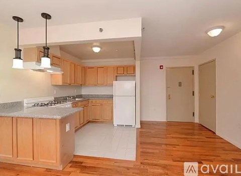 A kitchen with wooden cabinets and a white fridge.
