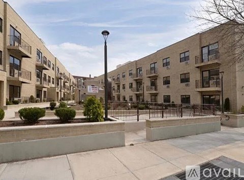 A row of apartment buildings with a street lamp in the foreground.