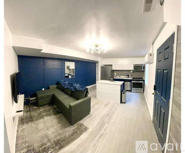 A living room with a couch and a television set.