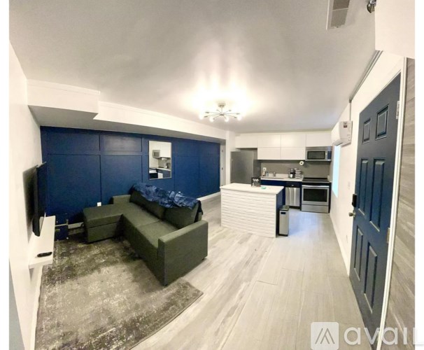 A living room with a couch and a television set.