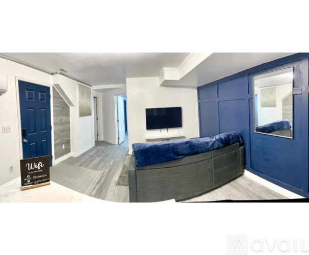 A living room with a blue couch and a television.