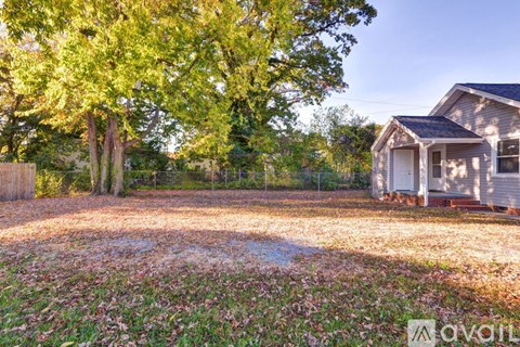 A house is for sale in a rural setting.