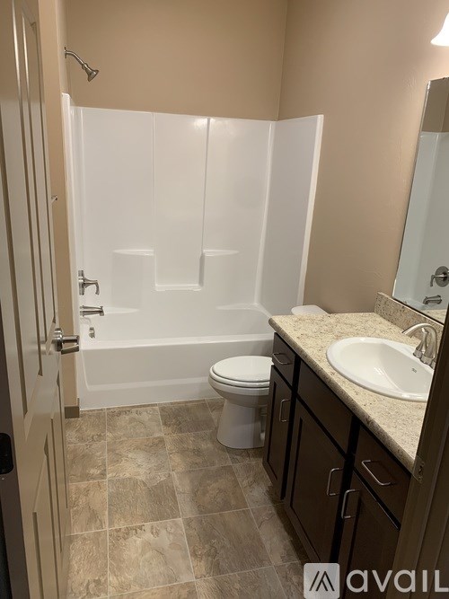 A bathroom with a toilet, sink, and shower.