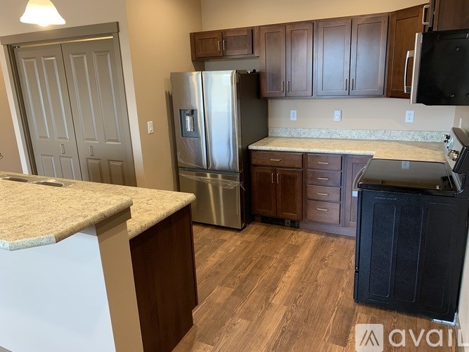 A kitchen with wooden cabinets and a granite countertop.