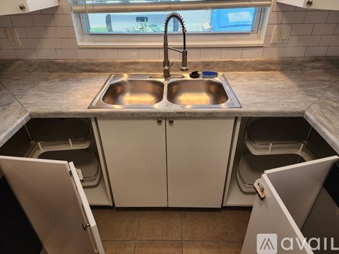 A kitchen with a sink and cabinets.