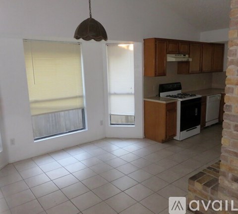 A kitchen area with a stove and a dining table.