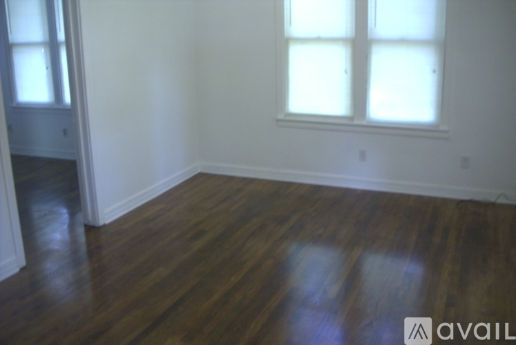 A room with wooden floors and a window.