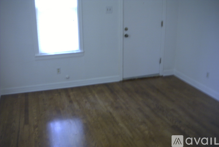 A room with wooden floors and a window.