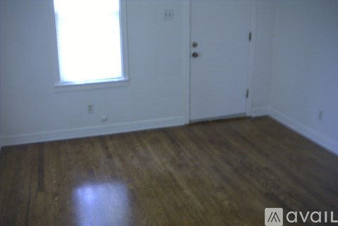 A room with wooden floors and a window.