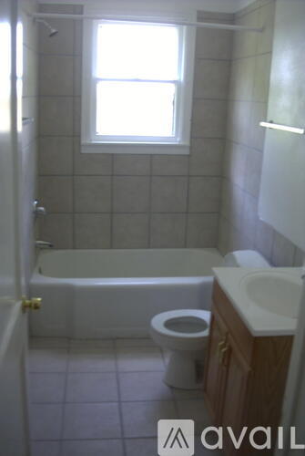 A bathroom with a toilet, sink, and bathtub.