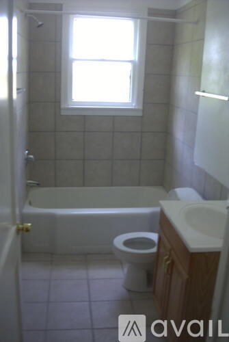 A bathroom with a toilet, sink, and bathtub.