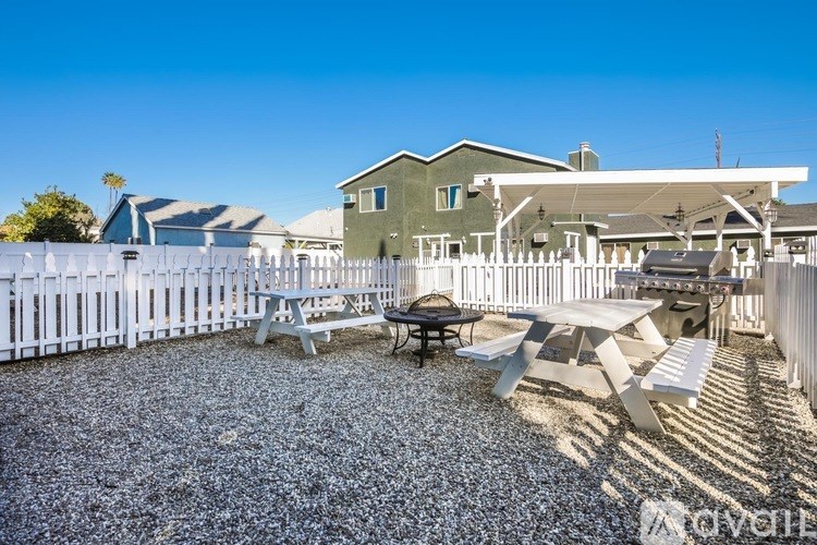 A backyard with a picnic table and chairs.