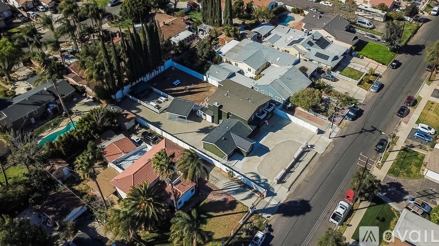An aerial view of a neighborhood with houses and palm trees.