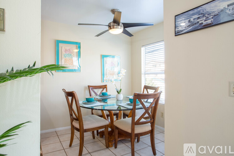 A dining room with a table set for four.