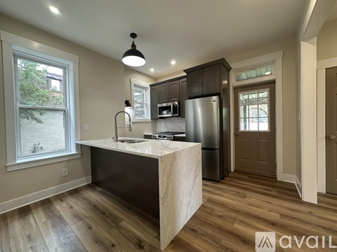 A kitchen with wooden floors and a large island.