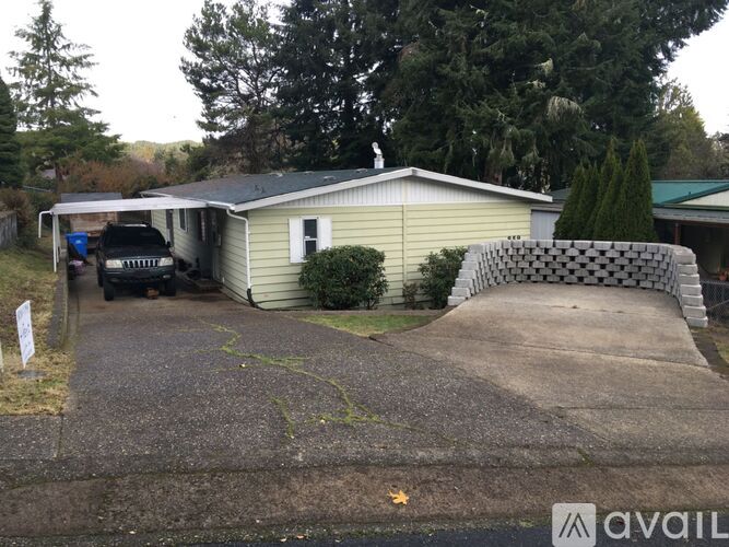 A house with a driveway and a car parked in front.
