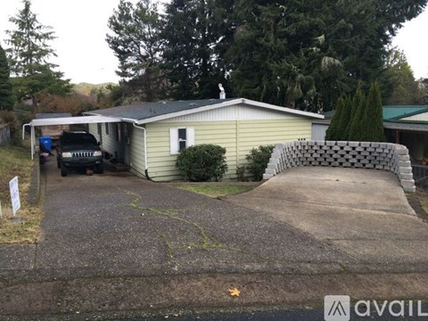 A house with a driveway and a car parked in front.