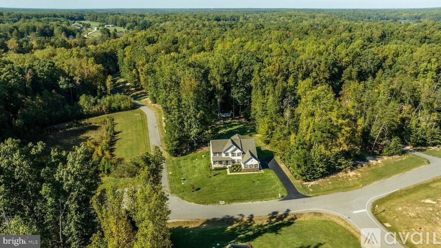 A house is surrounded by trees in a wooded area.