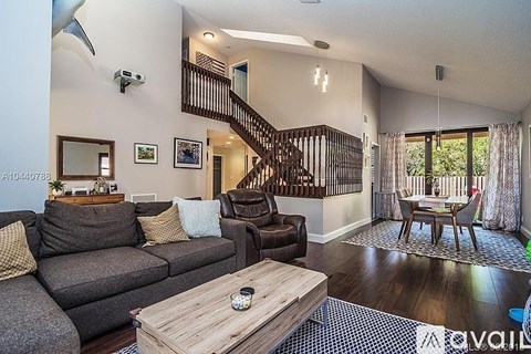 A living room with a grey couch and a wooden coffee table.