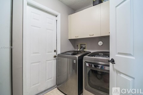 A kitchen with a stainless steel oven and microwave.