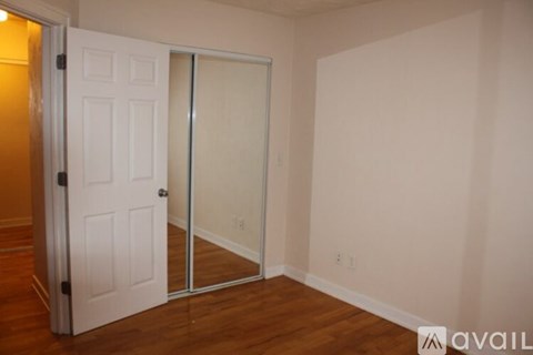 A room with a white door and a white wall.