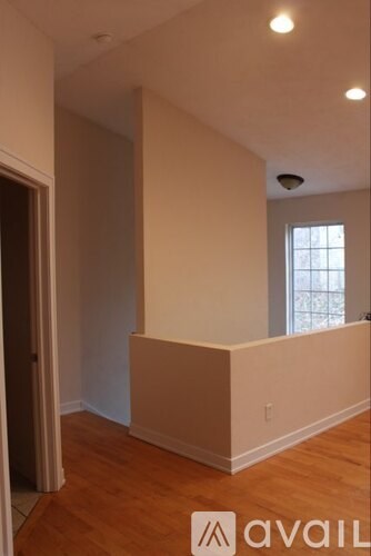 A room with wooden floors and a window.