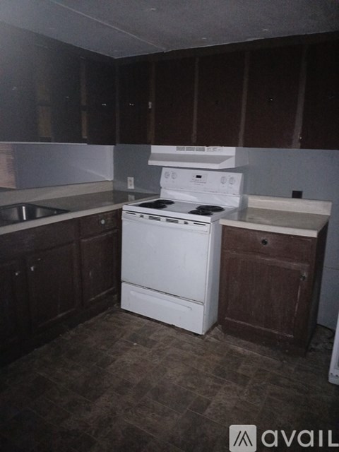 A kitchen with a white dishwasher and oven.