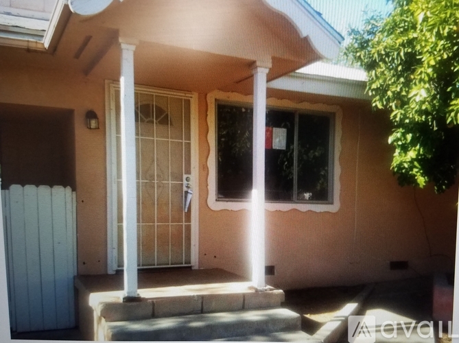 A house with a white fence and a glass door.