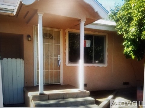 A house with a white fence and a glass door.