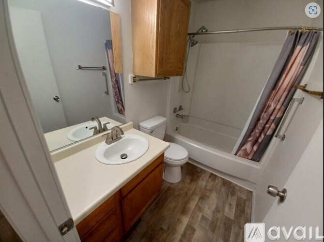 A bathroom with a sink, toilet, and bathtub.