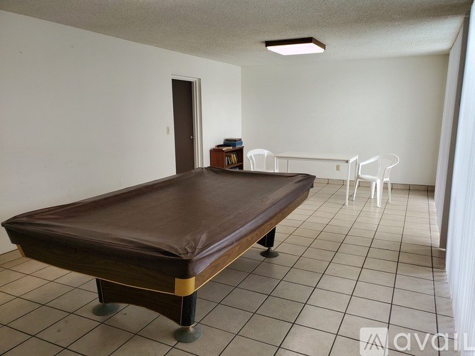 A room with a brown mattress on a wooden frame.