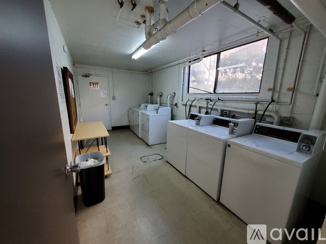 A room with a white washing machine and a window.