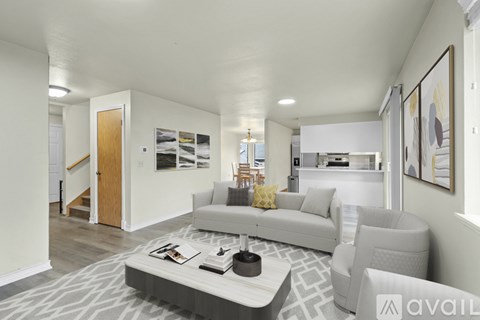 A living room with a grey couch and a coffee table.