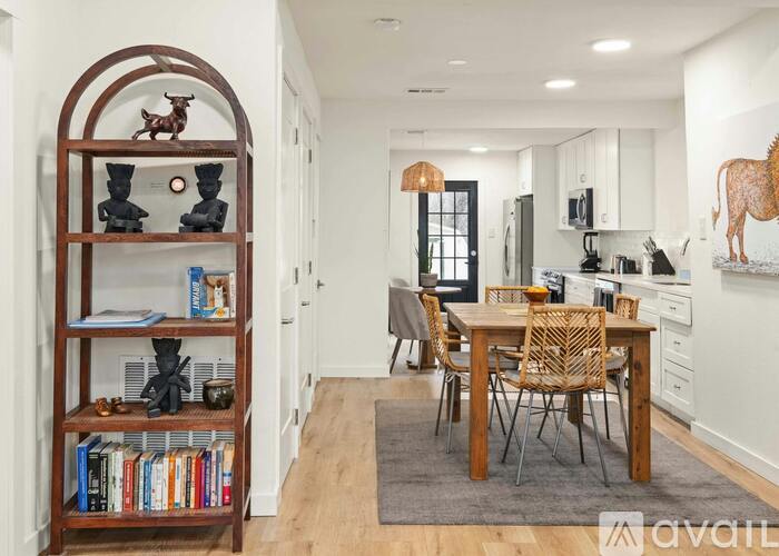 A modern kitchen with a dining table and chairs.