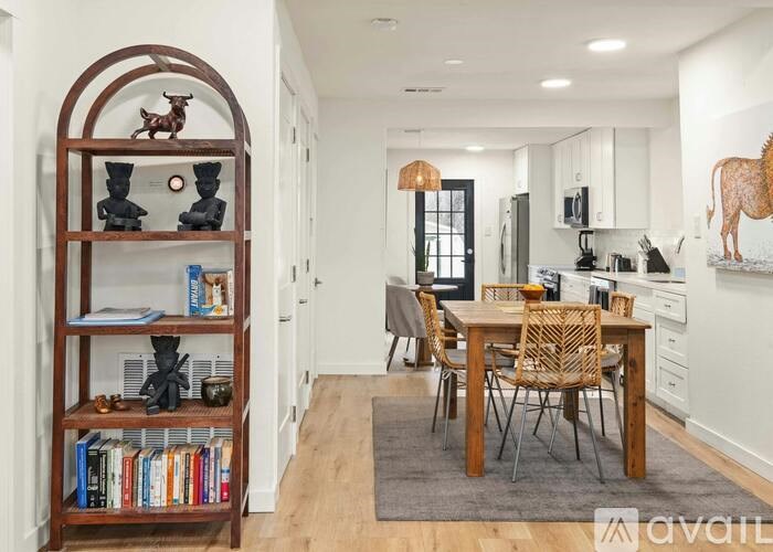 A modern kitchen with a dining table and chairs.
