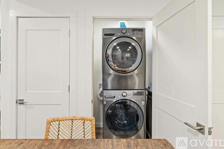 A washing machine is in a small laundry room.