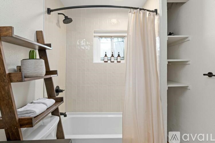 A bathroom with a white tub and a shower curtain.